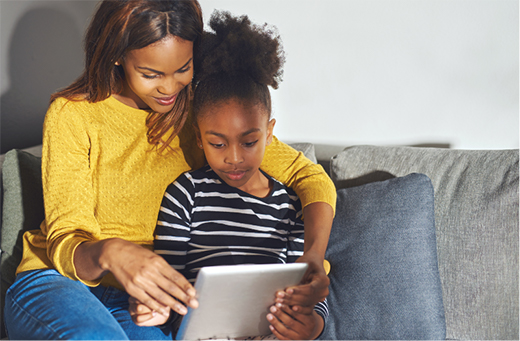 A mother with a child watching a show on a tablet