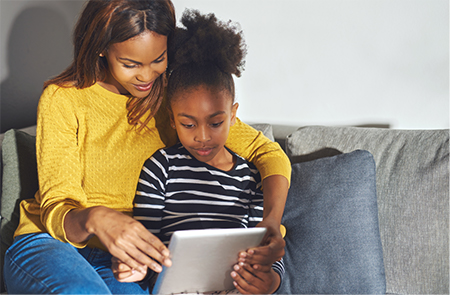 A mother and child watching a show