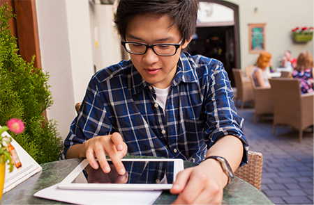 a young man working on a tablet computer