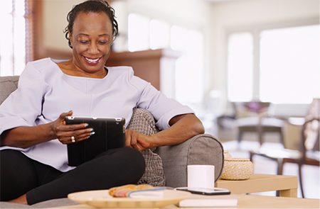 A woman watching a show on a tablet computer